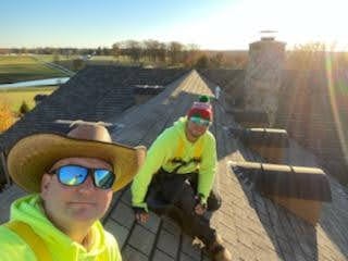 E.L.F. Designs team in safety gear on a rooftop during a Christmas light installation in Forest Hill, Maryland