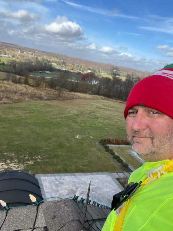 E.L.F. Designs crew member on a rooftop overlooking the Harford County, Maryland countryside during a lighting install