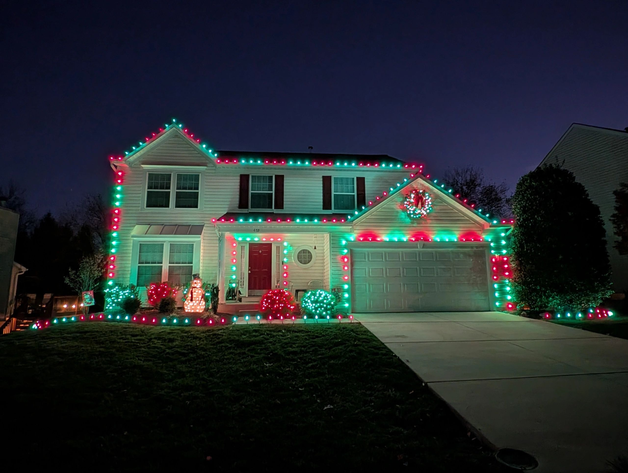 Red and green holiday lights decorate the home's roofline.